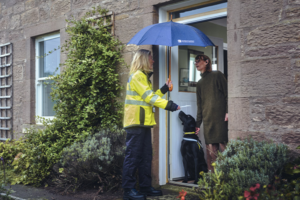 Image shows SSEN colleague talking to customer about PSR with their hearing dog